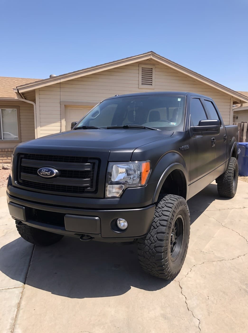 The same truck in the same spot, repainted matte black.